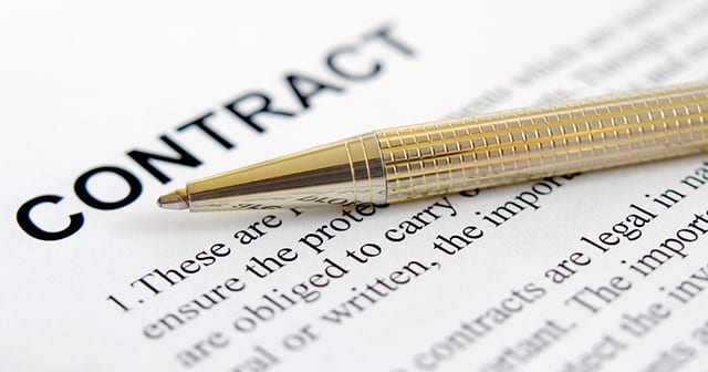 gold pen on contract